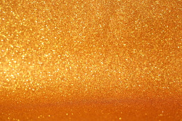 Defocused abstract gold, yellow, light brown lights background. Space. Wallpaper. Abstract glitter bokeh on black background