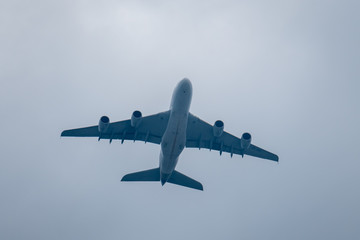 Huge large airplane in cloudy sky