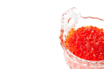 Red salmon caviar in a glass caviar bowl on a white background. Delicacy