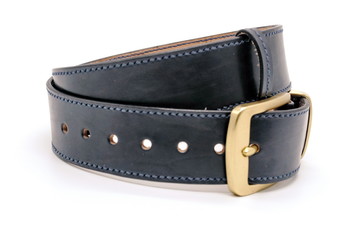 sample of classic leather men's belt with metal shiny buckle handmade in black twisted into a ball, the concept of manual craft,close up