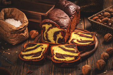 Whole and sliced sweet braided bread with walnuts