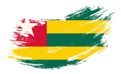 Obraz premium Togolese flag grunge brush background. Vector illustration.