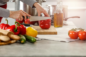 Hands in kitchen making meal.Table of free space for your decoration and fresh vegetables. 