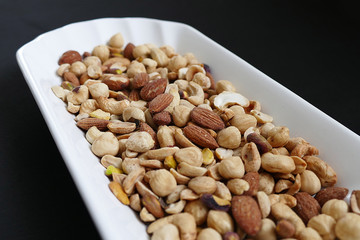 Nuts, cashews, almonds, Turkish nuts and nuts on black ground,