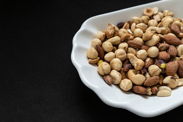 Nuts, cashews, almonds, Turkish nuts and nuts on black ground,