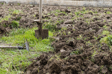 Fototapeta premium months of spring tillage, garden rake and shovel,