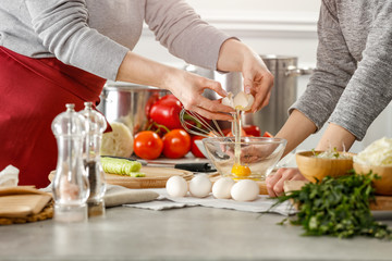 Hands in kitchen making meal.Table of free space for your decoration and fresh vegetables. 