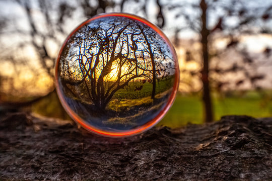 View through a crystal ball into the sunset Blick durch eine Glaskugel