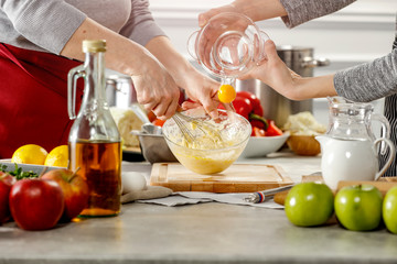 Hands in kitchen making meal.Table of free space for your decoration and fresh vegetables. 
