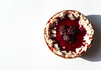 Delicious raspberry tartlet on a white background.