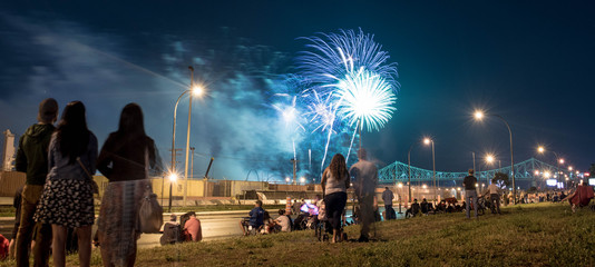 people watching fireworks. Jacques Cartier bridge with fireworks. Montreal Fireworks.