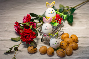 Easter Holiday. Funny eggs and flowers in the basket.