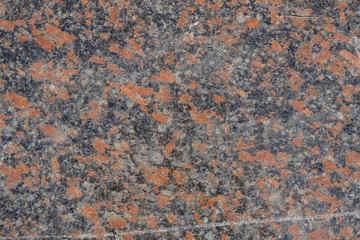 Granite surface in orange, gray, white, black mix. Copy space. Minimalism. 