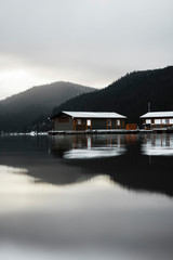Soft morning reflection of house on a lake