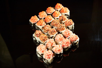 Various kinds of sushi roll set served on black stone. Japanese food