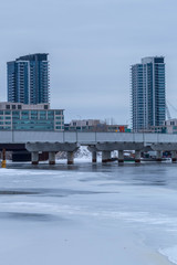 apartment building in town with frozen lake in winter
