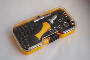 equiped Tool Kit. Instrument. Miter heads and keys. compact set in a yellow plastic box with a transparent cover.tools kit detail close up