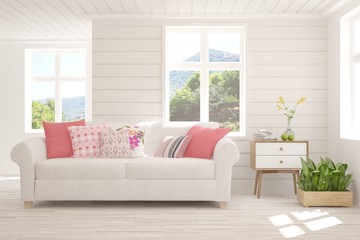 Minimalist living room in white color with sofa and summer landscape in window. Scandinavian interior design. 3D illustration