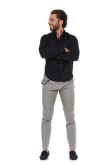 Confident Elegant Man Is Standing With Arms Crossed And Looking Away. Front View.