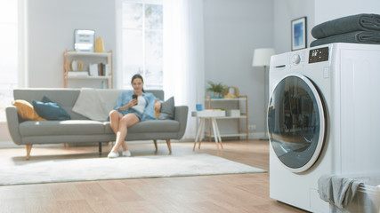 Shot of a Modern Technologically Advanced Washing Machine Working in a Bright and Spacious Living...