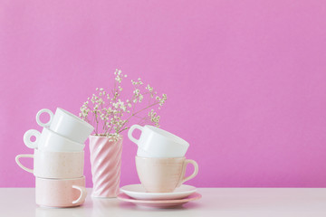 Fototapeta na wymiar modern cups on white table on background pink wall