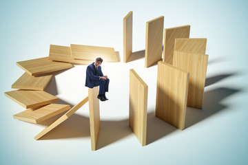 Businessman in domino effect concept