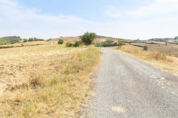 a gravel road through agricultural fields next to Proceno, Province of Viterbo, Lazio region, Italy