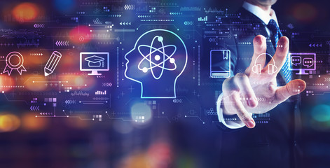 Online education concept with businessman on night city background