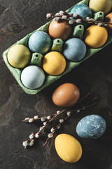 Easter background. Natural dyed easter eggs on dark stone background.