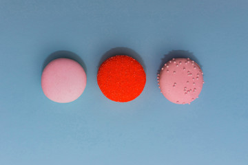 Three multi-colored macaroon on flat background