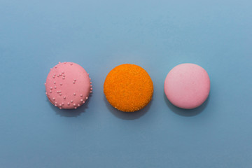 Three multi-colored macaroon on flat background