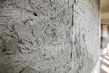 Shallow depth of field (selective focus) image with a wall in an unfinished building on a hospital construction site.