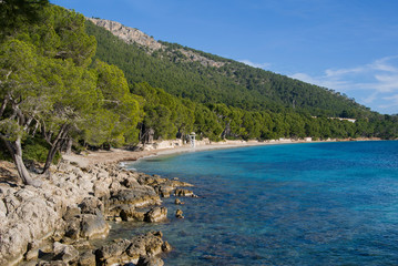 Fototapeta na wymiar Beautiful scenery on the coast of Majorca. Sea and hills covered with green forests. Majorca, Spain