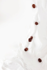 Coffee milk dessert. Coffee beans among yogurt or milk.