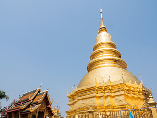 Fototapeta premium The large golden pagoda in the traditional northern Thai style.