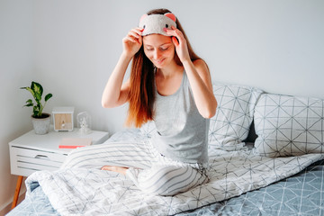 Woman getting ready in sleeping mask
