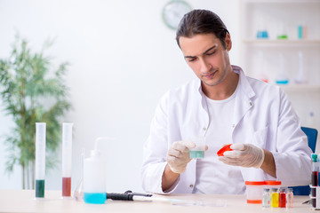 Young male chemist working in the lab