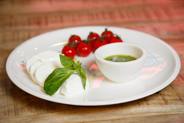 cheese and tomatoes with sauce on a white plate