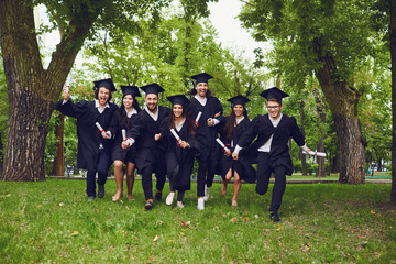 A group of graduates fun in the park.