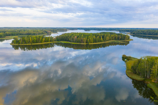 To Aglona small town and beautiful Latgale lakes in summer. Reflection on the lake gorgeous clouds and sky. Aglona, Latgale, Latvia (series)