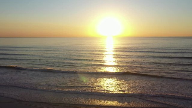 Flying Towards the Sun at Sunset Time Over the Ocean