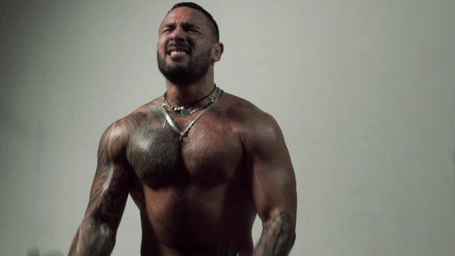 Handsome man lifting dumbbell. Like hard sports. Man gym working out with weights.