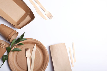 eco friendly dishes on a colored background top view. Eco-friendly disposable tableware. The...