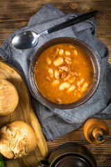 Beans with tomato sauce, bacon and sausage.