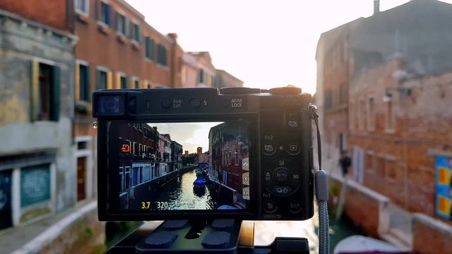 Close shot of the screen of a camera taking picture of a street of Venice