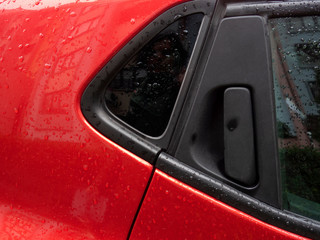 red car door handle close up