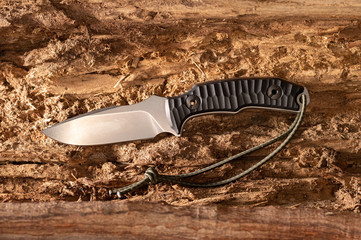 A knife in the middle of a tree. Knife and wooden texture.