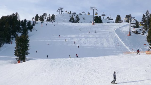 Skiers on ski slopes in Penken area, Mayrhofen ski resort, Tyrol, Austria.