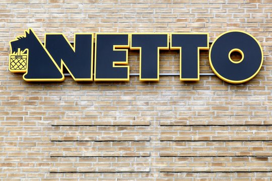 Malling, Denmark - August 19, 2017: Netto sign on a wall. Netto is a Danish discount supermarket operating in several European countries. Netto is owned by danish Supermarket Group