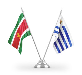 Uruguay and Suriname table flags isolated on white 3D rendering